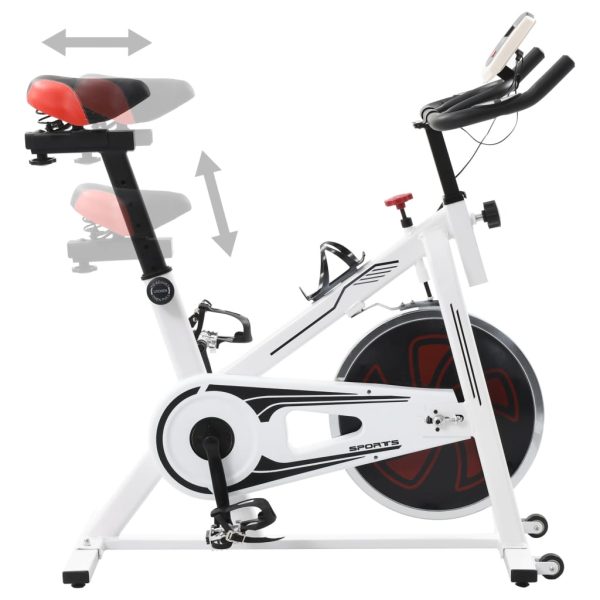 Bicicleta de entrenamiento con sensores de pulso blancos y rojos. - Imagen 3